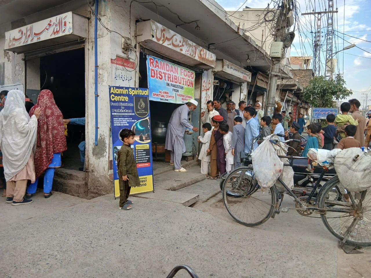 People gathering outside Alamin’s food distribution point in Pakistan