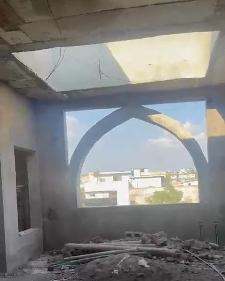 An arched window in the unfinished prayer hall of the mosque